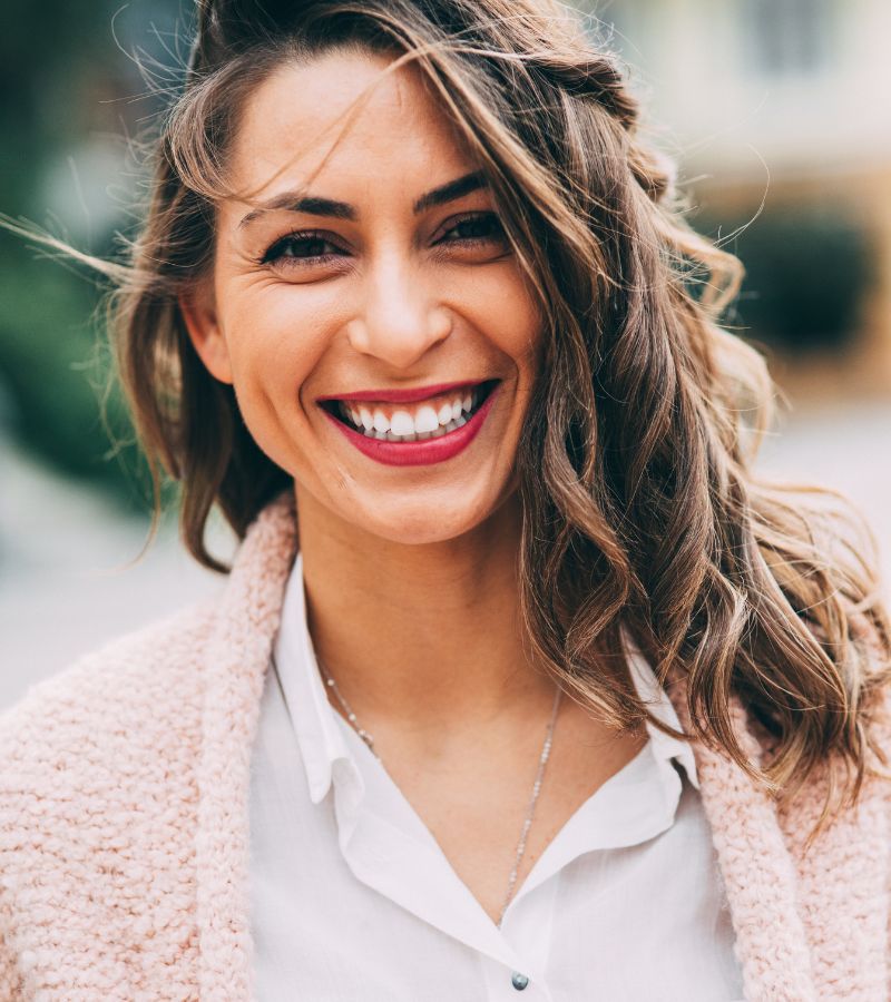 Happy woman outdoors excited about her personalized women's health program
